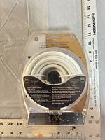 Front view of sealed blister pack showing coiled white cable and Acoustic Research branding