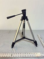 Tripod fully opened to medium height showing pan/tilt head and handle