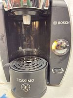 Front view showing Bosch logo, control dial, drip tray
