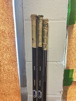 Upper handles of three sticks showing cloth tape and number 17 markings