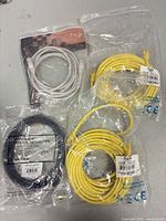 Four sealed Ethernet cables: white, yellow x2, black