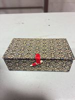 Patterned fabric-covered box closed, showing top and closure