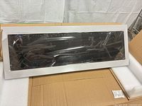 Front view of silver bar display in foam packaging