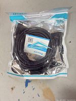 Front of sealed DTECH package showing coiled black cable and DB9 female connector ends