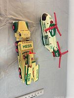 Truck, trailer and helicopter with ruler for scale