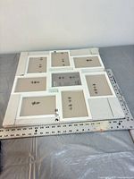 Overall view showing white multi-opening frame with packaging corners