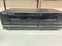 Front view showing dual cassette wells, control buttons and branding