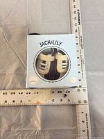Front view of boxed Jack & Lily baby shoes with measuring rulers