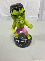 Front view of Hulk bobblehead on round base