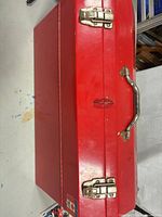 Closed red Mastercraft toolbox, top view showing handle and latches