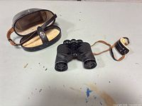 Binoculars, case and lens cap overview