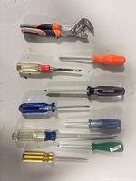 Full set laid out showing pliers and nine screwdrivers