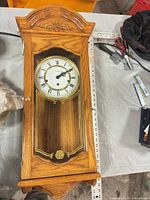 Full view oak longcase clock with glass door closed