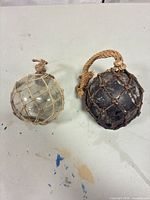 Both glass floats side by side on table