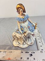 Front view showing full figurine with ruler for scale