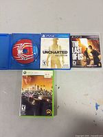 Front view of three cased games and open Spider-Man disc case