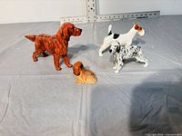 group shot of all four porcelain dog figurines