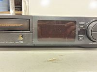 Front-right of unit with model number SLV-494HF, display window, control buttons, visible surface scratches