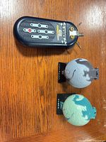 CommTech reader and two closed planet pods on table