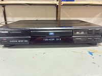 Front three-quarter view of Toshiba SD-1600 DVD player showing full chassis and display