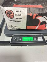 Closed box on scale showing Tree Island branding and weight