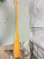 Full view of wooden canoe paddle on table