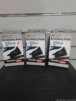 Three boxed ChatterBox X1 Slim accessory packs front view