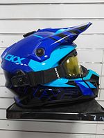 Right side view of blue CKX Titan helmet with attached goggles