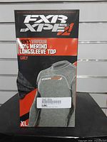 Front of boxed FXR Vapour longsleeve top showing model, size XL