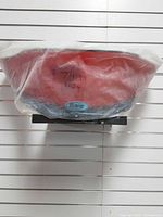 Windshield in protective plastic bag on shelf