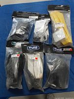 Six sealed Polaris Pure handguard bags on table