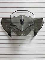 Front view of clear and smoke-tinted adjustable windshield with mounting brackets