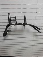 Both black metal scabbard mounts displayed on wall slat