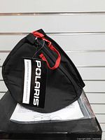 Cover standing on edge showing overall shape with tag attached