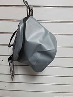 Side view of gray waterproof bag hanging on hook