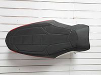 Top view showing black vinyl surface with stitched sections and red side accent