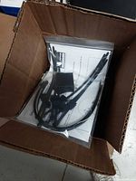 Bag containing zip ties, connectors and instruction sheet inside box