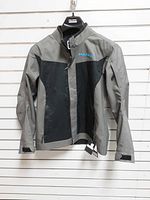 Full view of front of Polaris gray/black riding jacket hanging