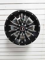 Front view of Raceline wheel rim showing machined spokes and center cap