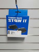 Front of Rhino-Rack STOW IT retail box showing product name and image of two holders
