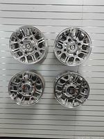 Front view all four chrome rims mounted on display wall