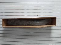 Ski inside original cardboard box with protective wrap