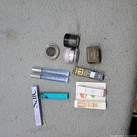 Group shot of all nine beauty items laid out on grey surface