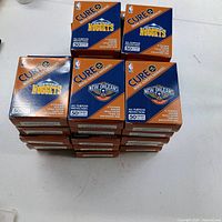 Stack of 25 Cure It adhesive bandage boxes showing Nuggets and Pelicans branding