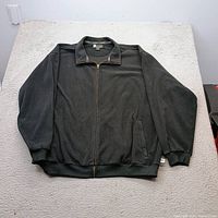 Jacket laid flat showing front, collar, zipper, pockets, cuffs, waistband