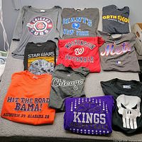 Overview of all ten tee shirts laid out showing graphics and colours