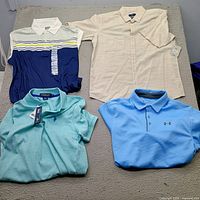 All four new men’s size small shirts laid out together