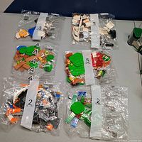 Six sealed Lego set component bags laid out on table
