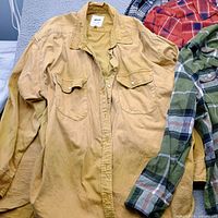 Gap mustard shirt foreground, Old Navy green plaid, Pink Rose red plaid, partial Aerie plaid shirt