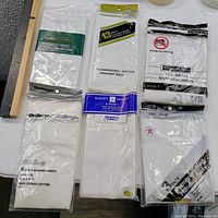 Group shot of all sealed packages of men’s handkerchiefs on table